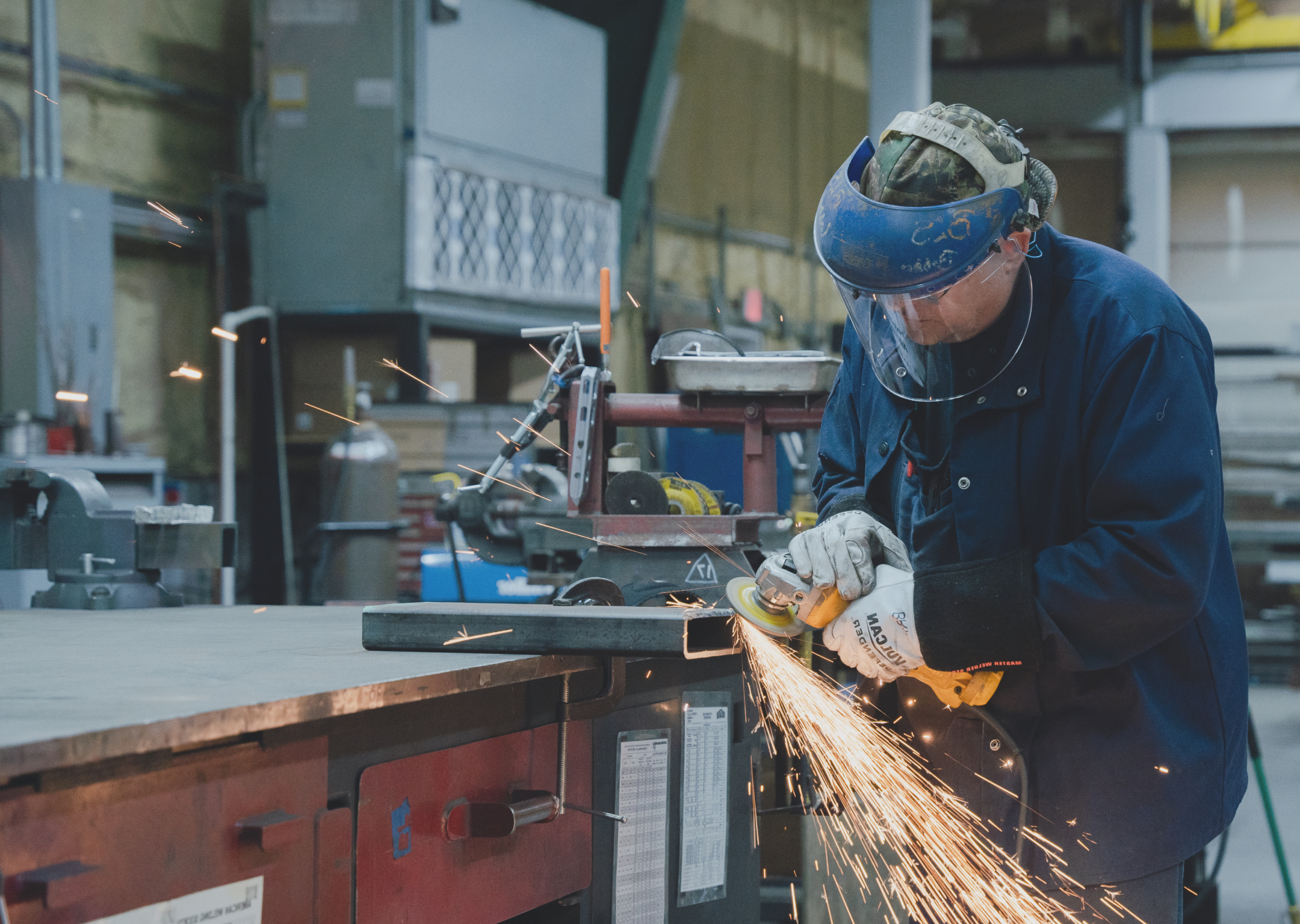 Hills Inc. technician working with industrial extrusion equipment.